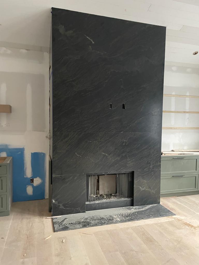 Elegance Redefined: Transforming Fireplaces with Honed Black Panther Granite