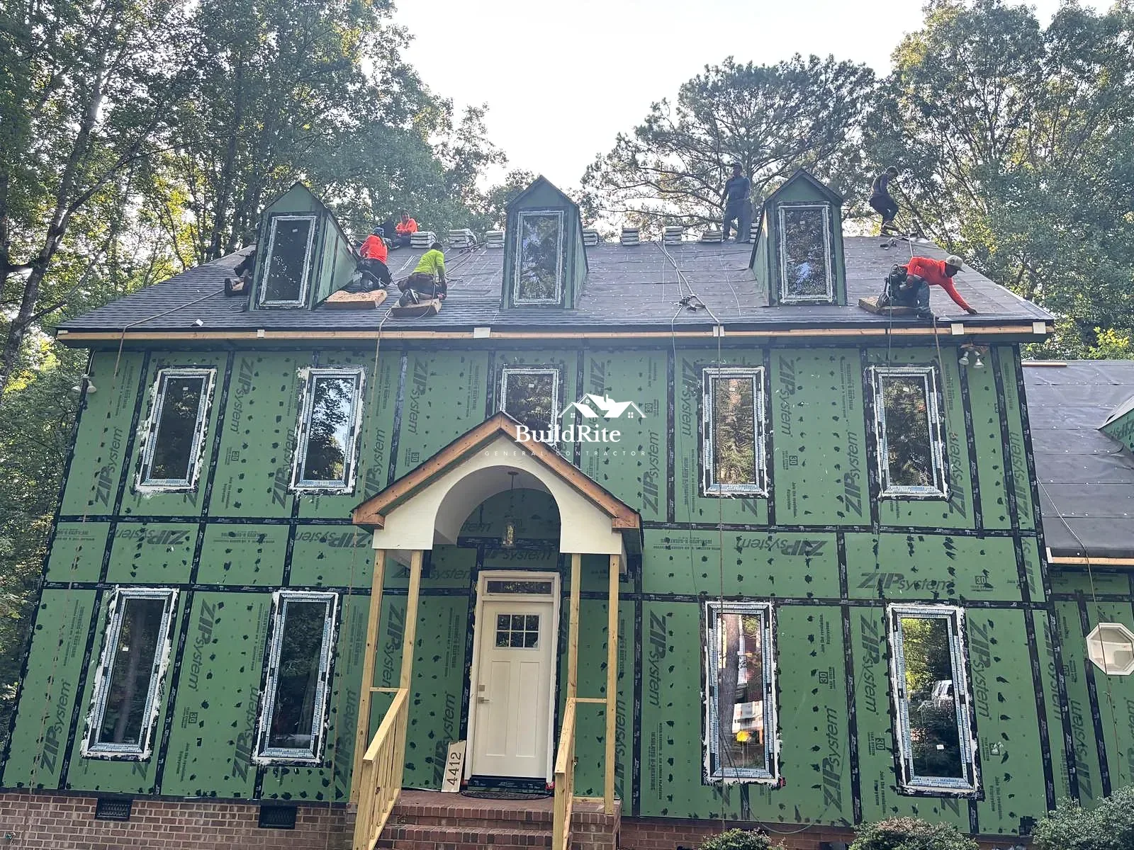BuildRite roofing crew working around dormer windows on a home in Apex NC
